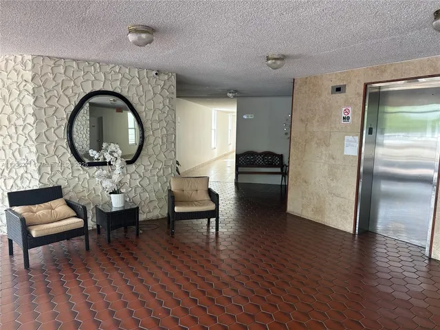 a living room with furniture and a large mirror