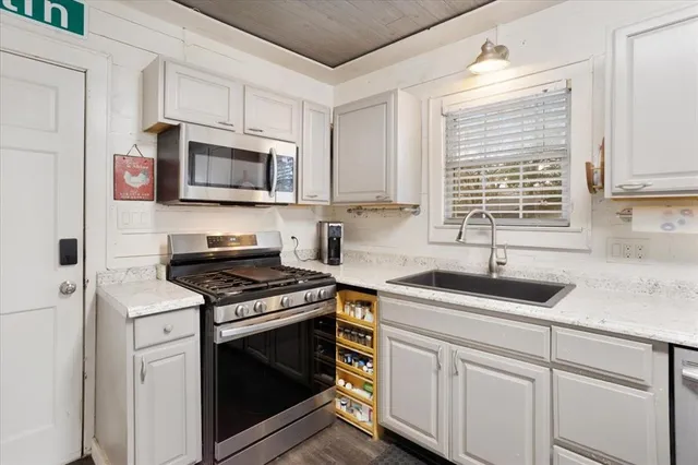 a kitchen with counter top space and wooden floor