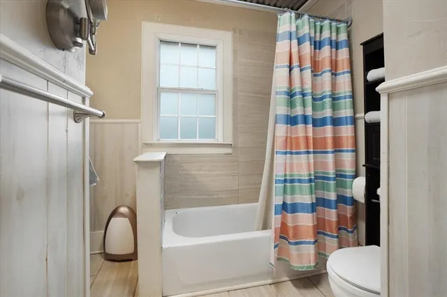 a bathroom with a shower and a sink