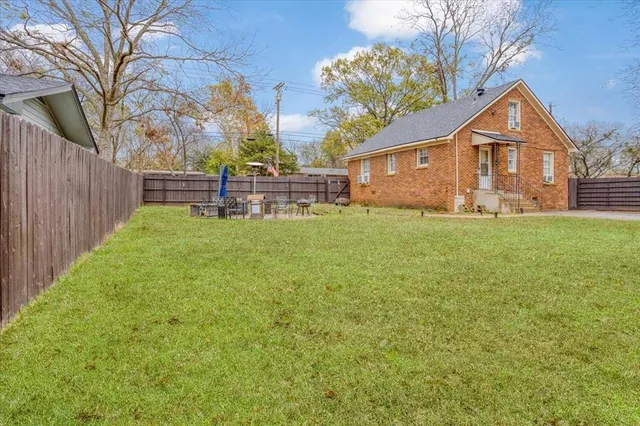 a view of a yard with a large tree