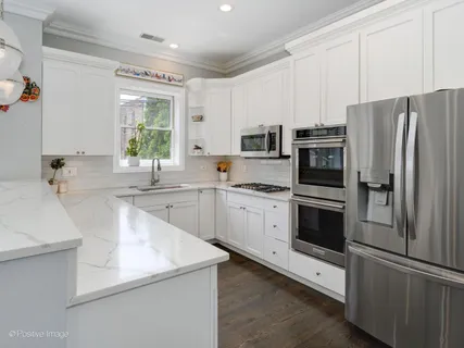 a kitchen with appliances a sink and a counter top space