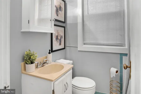 a bathroom with a sink toilet and mirror