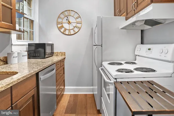 a kitchen with stainless steel appliances granite countertop a stove and a refrigerator