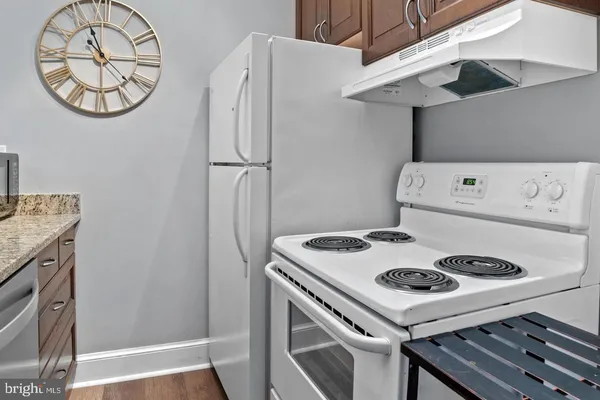 a kitchen with a stove and a refrigerator
