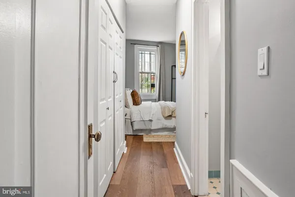 a view of a bedroom with a bed and wooden floor