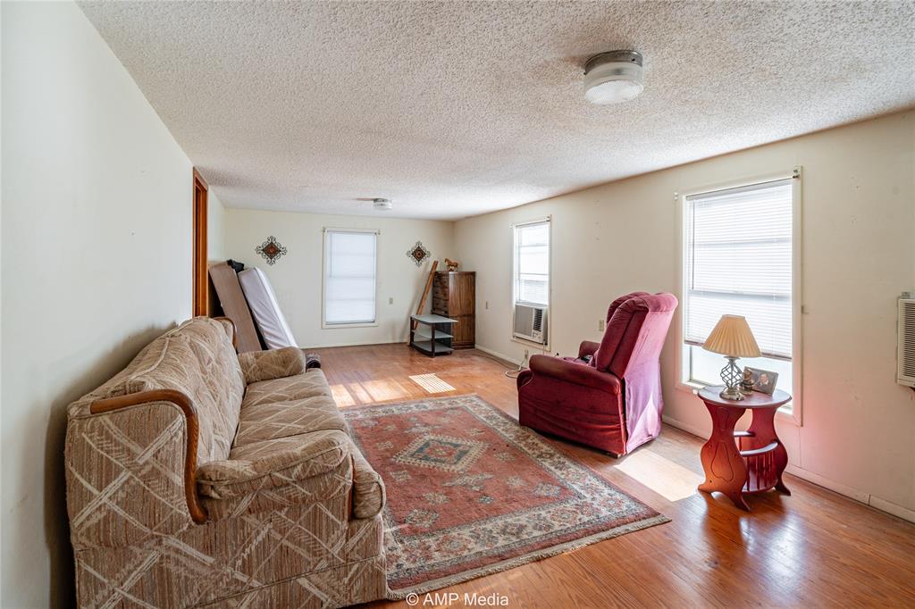 1992 Sand Flat Road Jacksboro, TX 76458 - Photo 18 of 36 Living room featuring a textured ceiling and light hardwood / wood-style floors