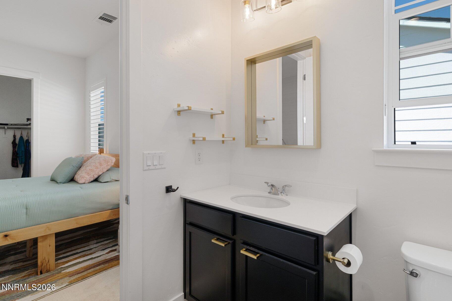 6110 South Pleasant Oak Trail Reno, NV 89511 - Photo 34 of 66 a bathroom with a sink and a mirror