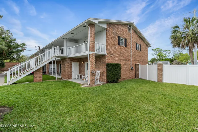 a view of house with yard and swimming pool