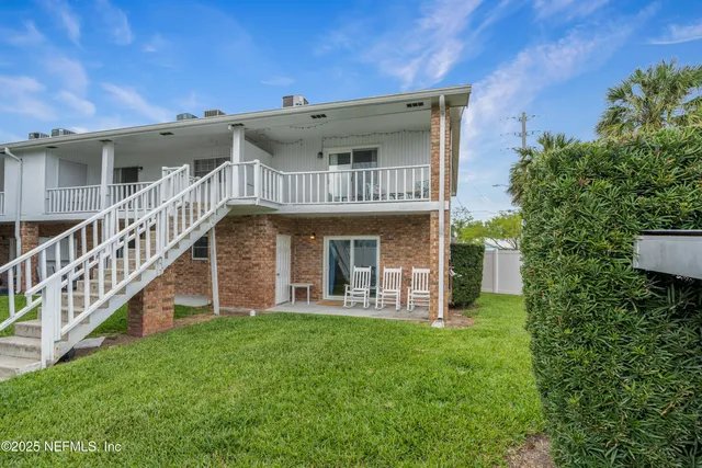 a view of a house with a yard and porch