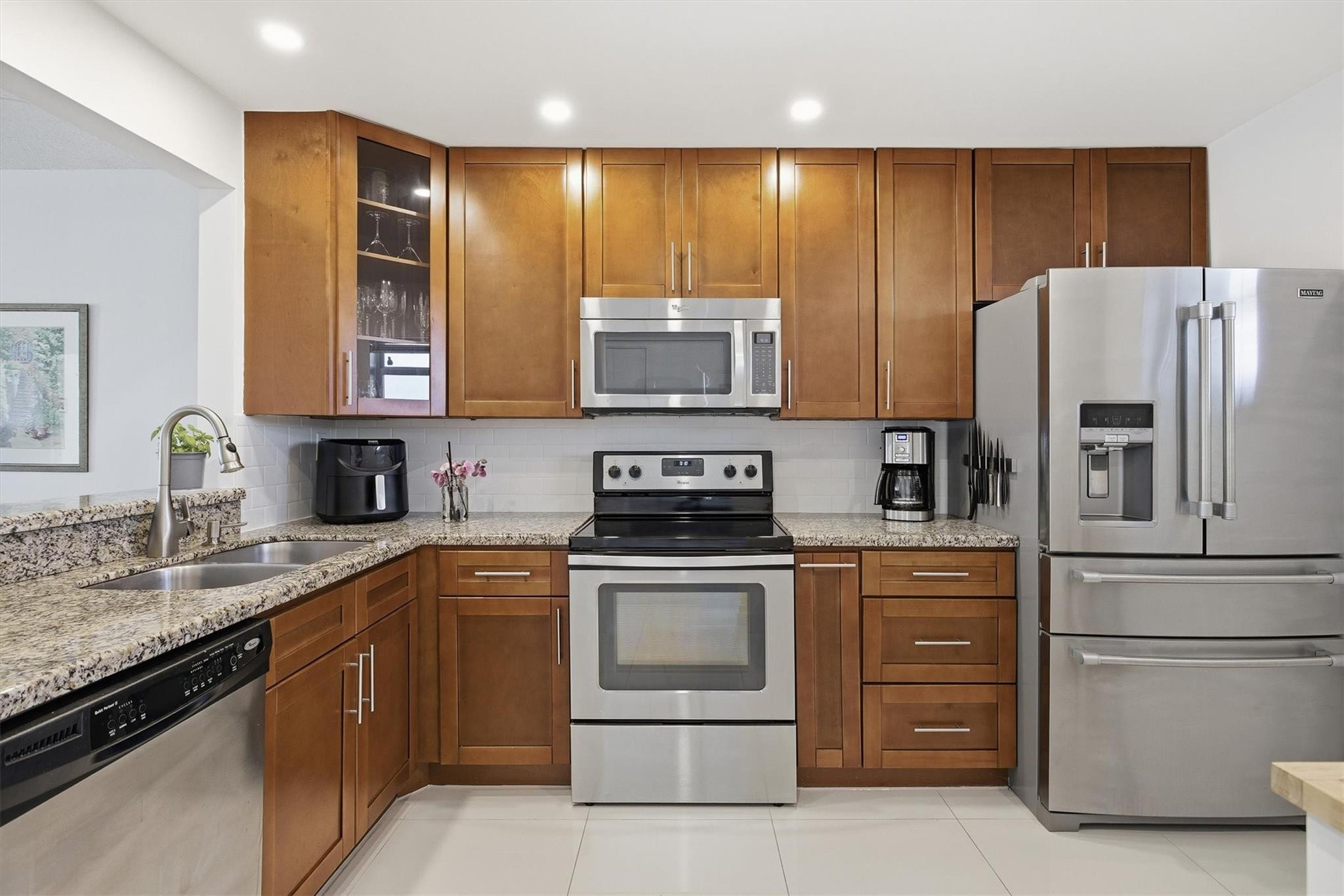 3930 Inverrary Boulevard, Unit 605D Fort Lauderdale, FL 33319 - Photo 15 of 52 a kitchen with a stove sink and refrigerator