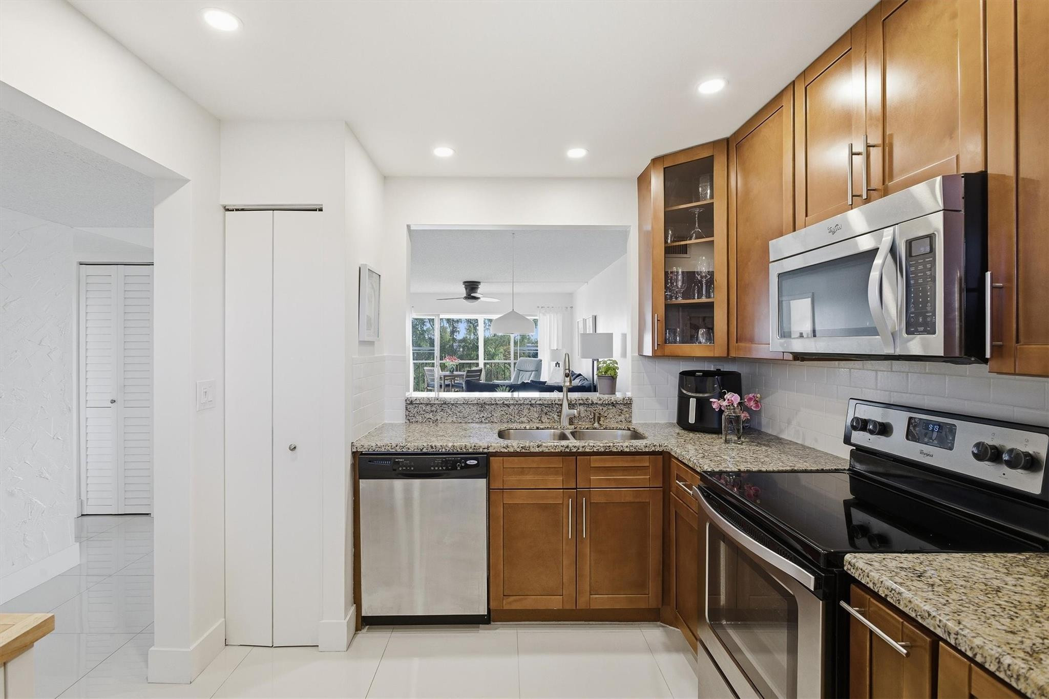 3930 Inverrary Boulevard, Unit 605D Fort Lauderdale, FL 33319 - Photo 16 of 52 a kitchen with a sink stove top oven and refrigerator