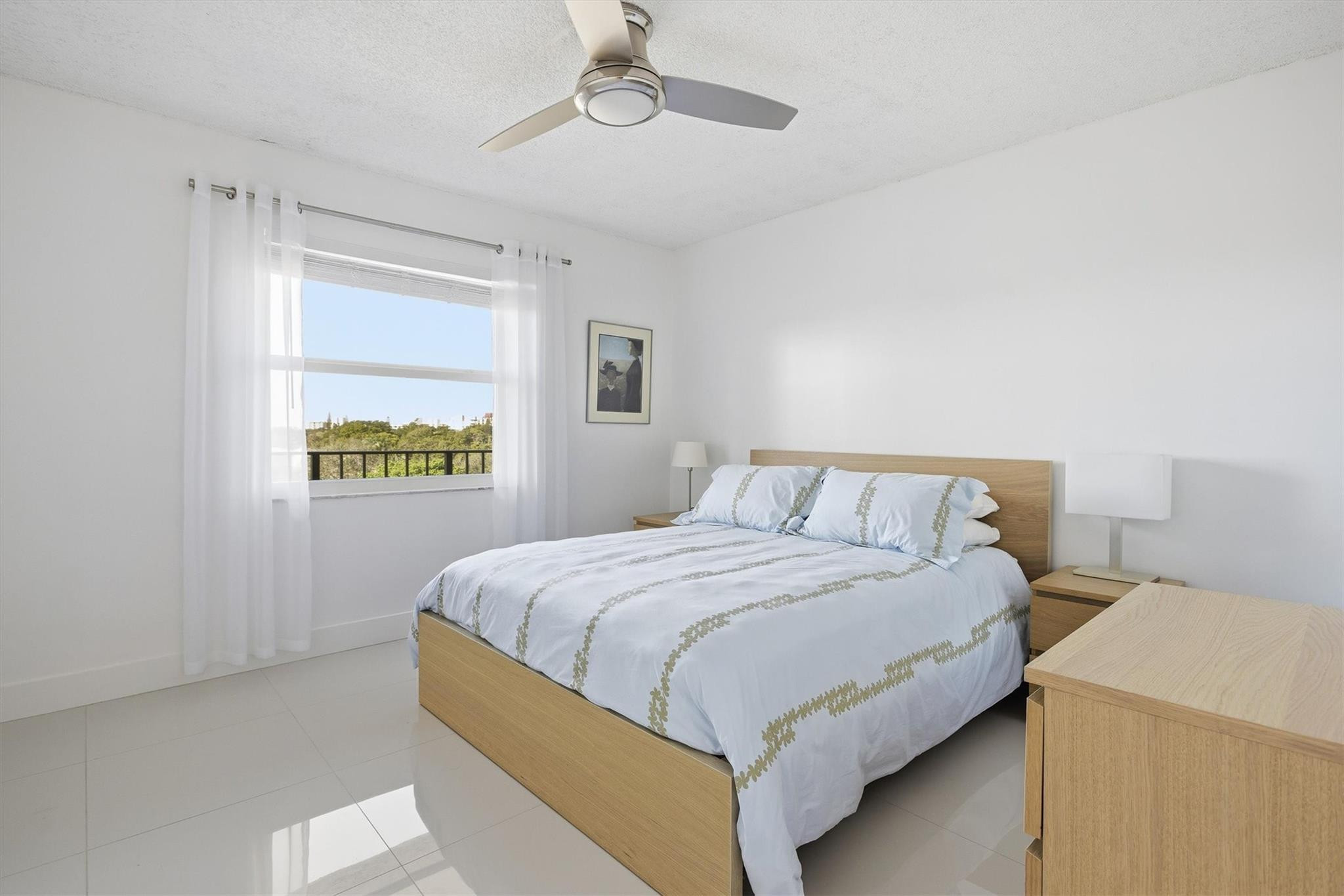 3930 Inverrary Boulevard, Unit 605D Fort Lauderdale, FL 33319 - Photo 26 of 52 a bedroom with a bed and a chandelier