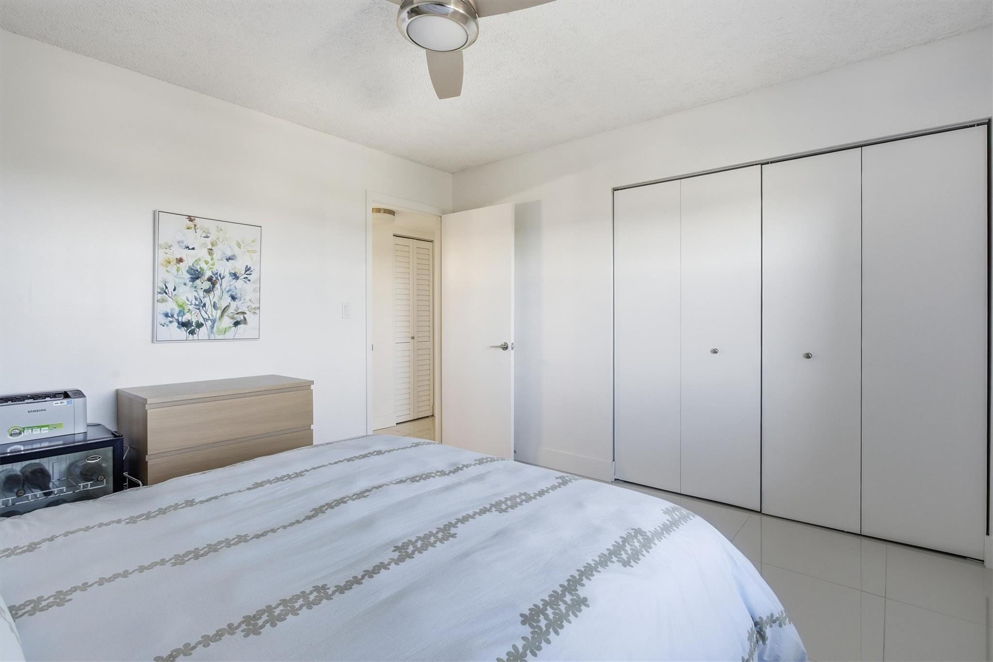 3930 Inverrary Boulevard, Unit 605D Fort Lauderdale, FL 33319 - Photo 27 of 52 a bedroom with a bed and a painting on the wall