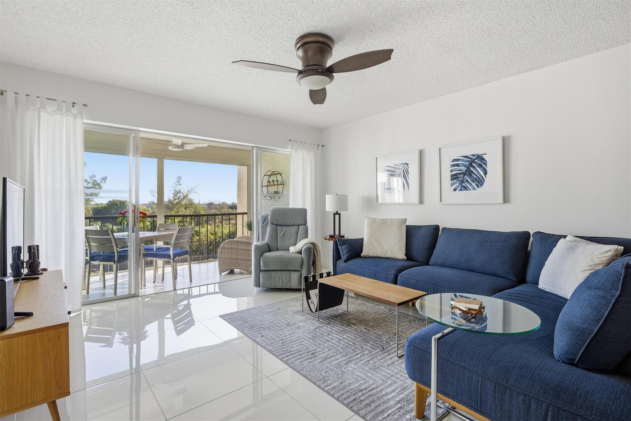 3930 Inverrary Boulevard, Unit 605D Fort Lauderdale, FL 33319 - Photo 3 of 52 a living room with furniture and a large window