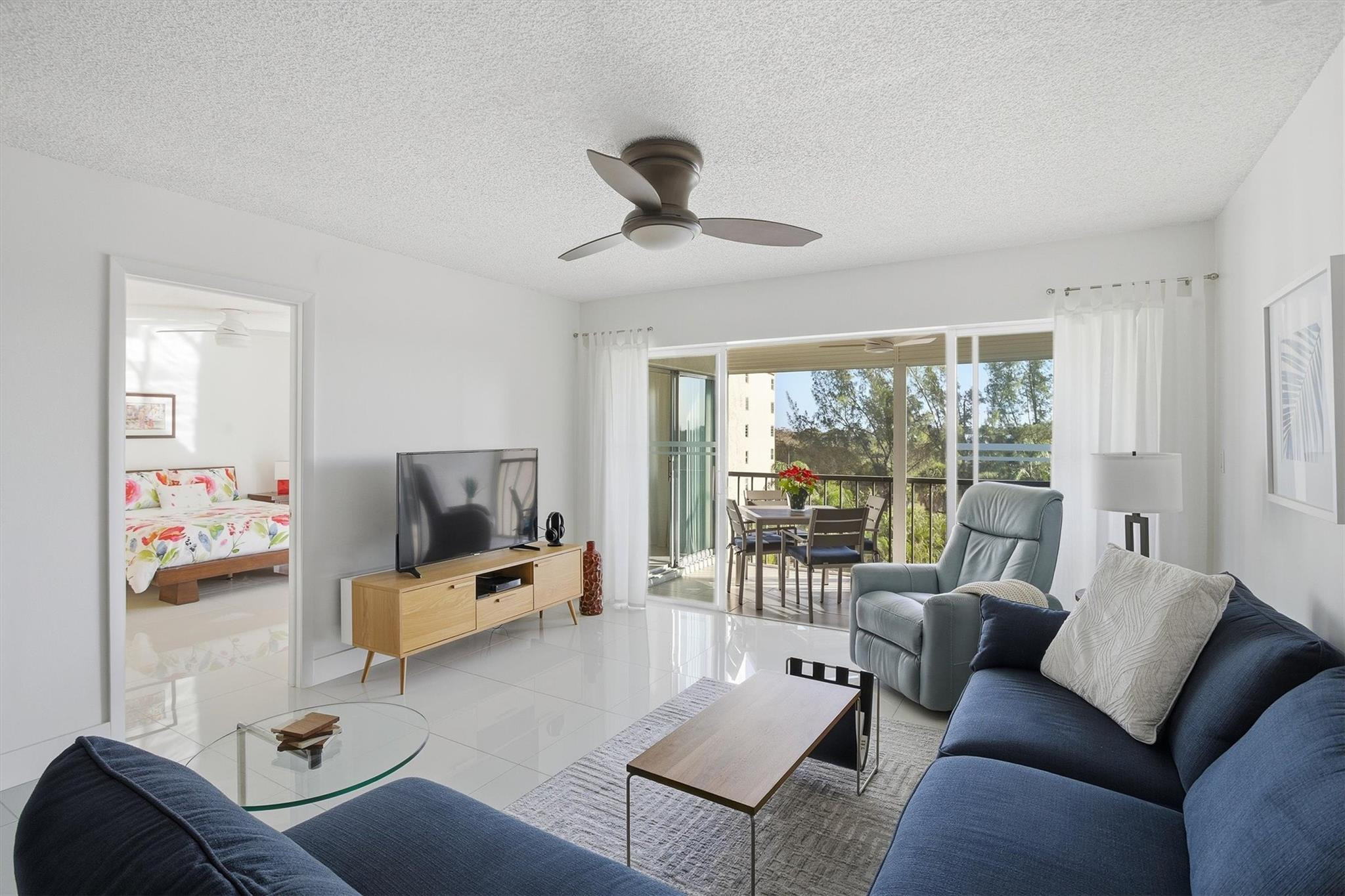 3930 Inverrary Boulevard, Unit 605D Fort Lauderdale, FL 33319 - Photo 4 of 52 a living room with furniture and a flat screen tv