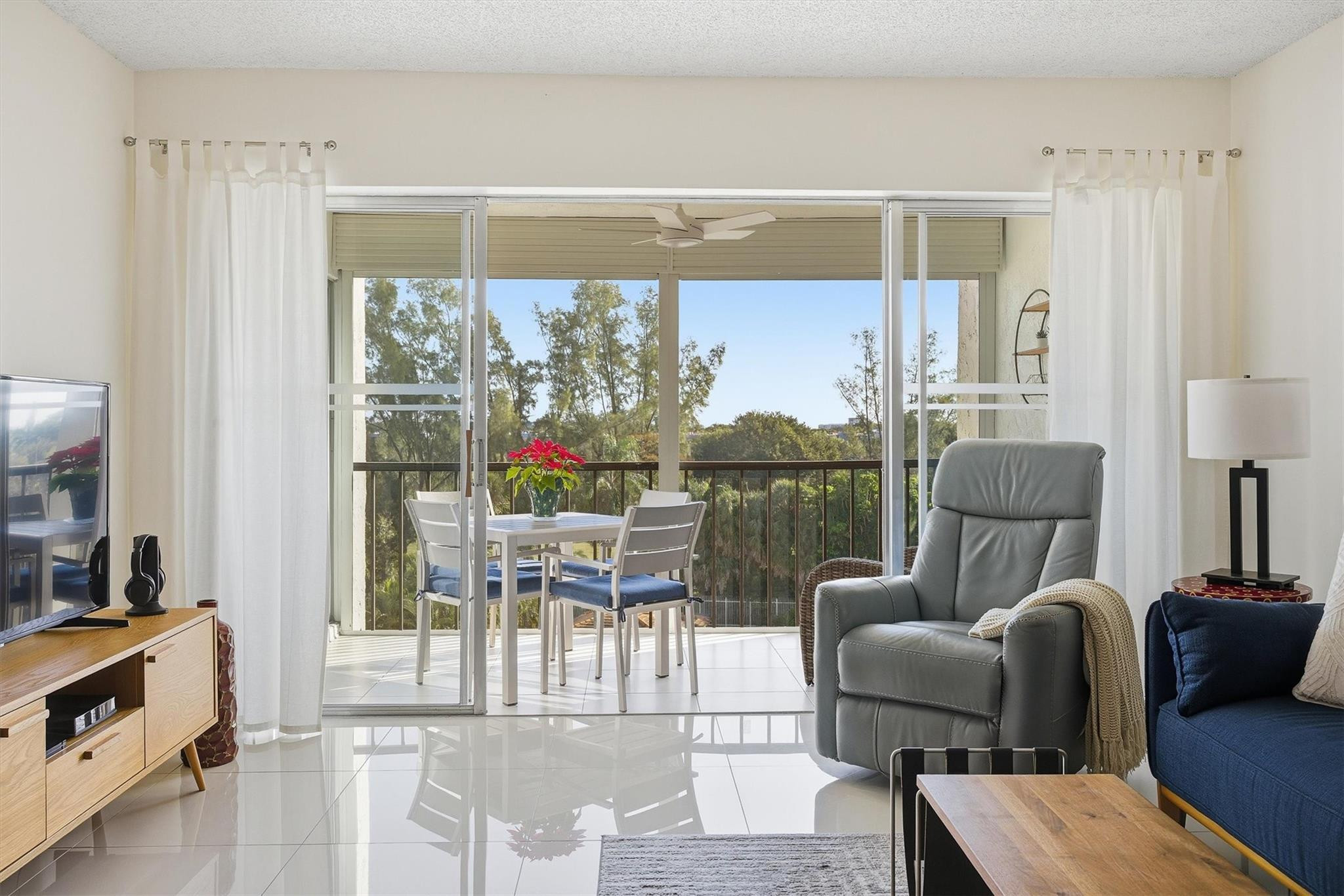 3930 Inverrary Boulevard, Unit 605D Fort Lauderdale, FL 33319 - Photo 6 of 52 a living room with furniture and a floor to ceiling window