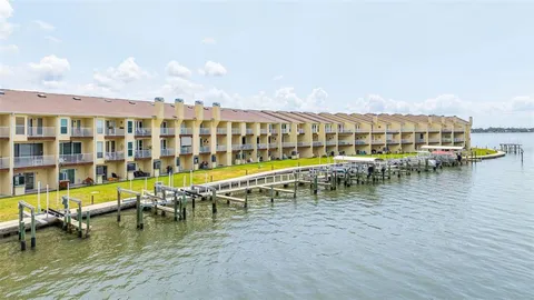 a view of a swimming pool with outdoor seating