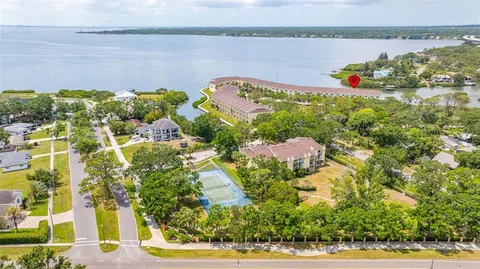 a view of a lake with couches chairs