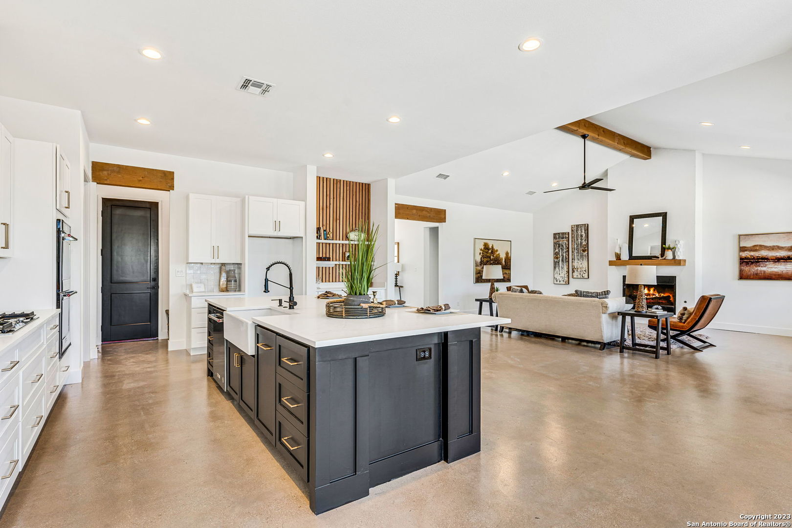 a kitchen with sink stove and refrigerator