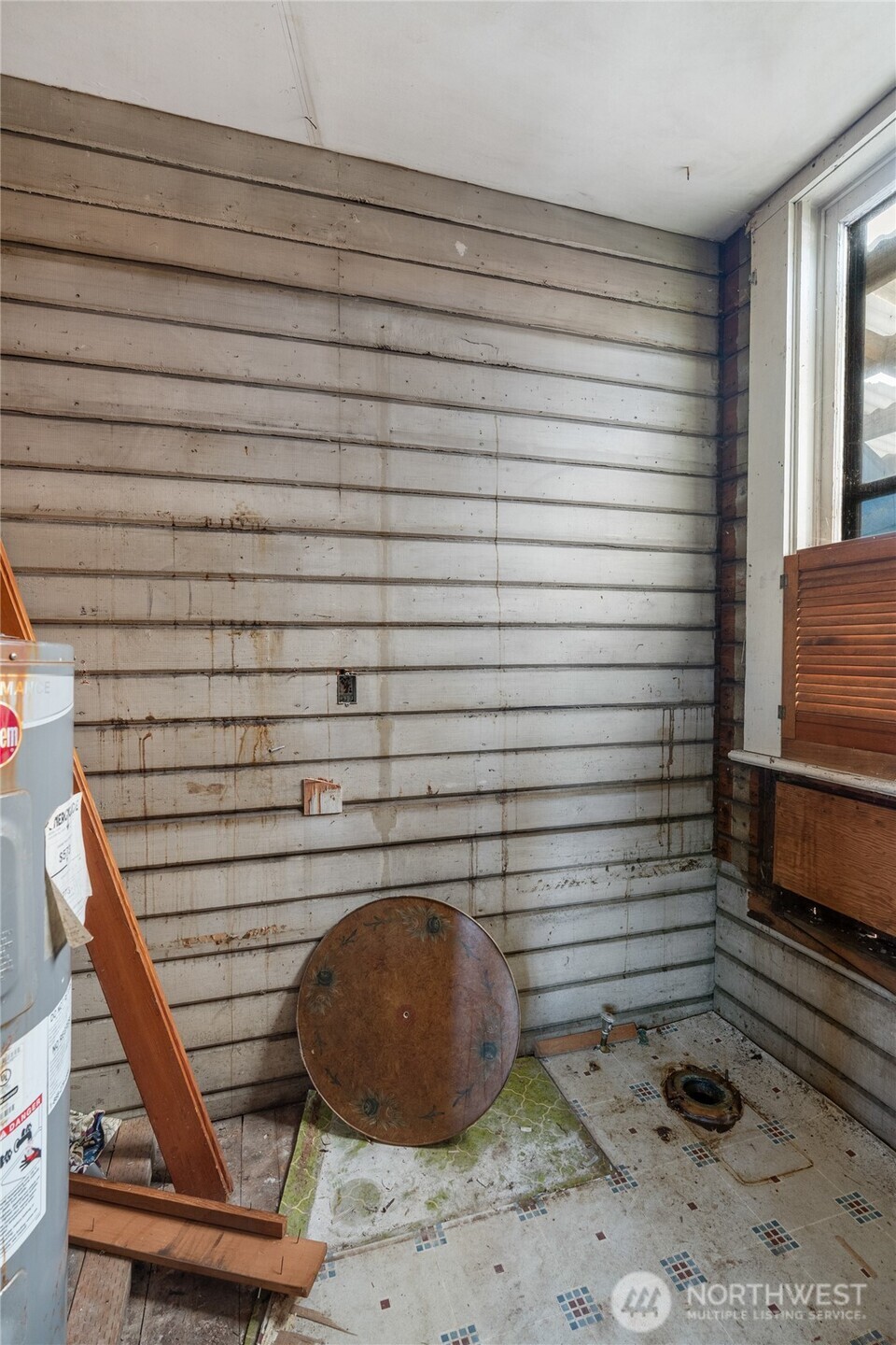 504 9th Street Hoquiam, WA 98550 - Photo 20 of 40 a room with water heater and wooden walls