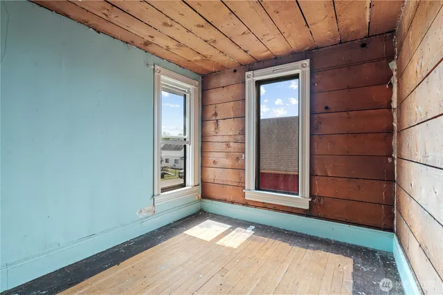 an empty room with a empty space and windows