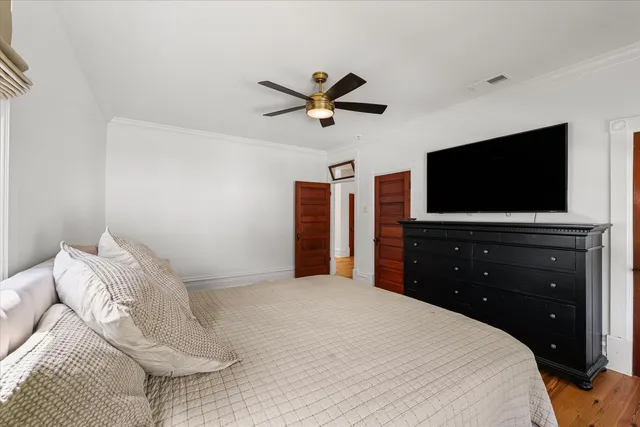 a view of backyard of house with wooden fence and large trees