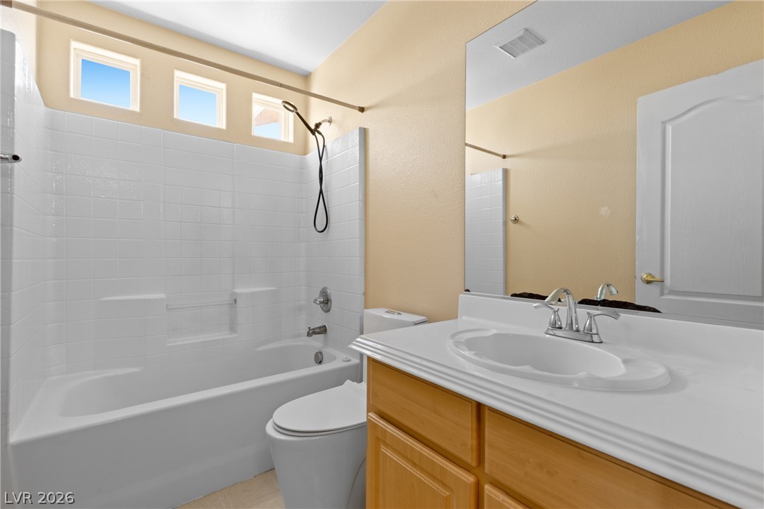 8934 Deep Ridge Court Las Vegas, NV 89178 - Photo 18 of 47 A well-lit primary bathroom provides a convenient and comfortable bathing experience.