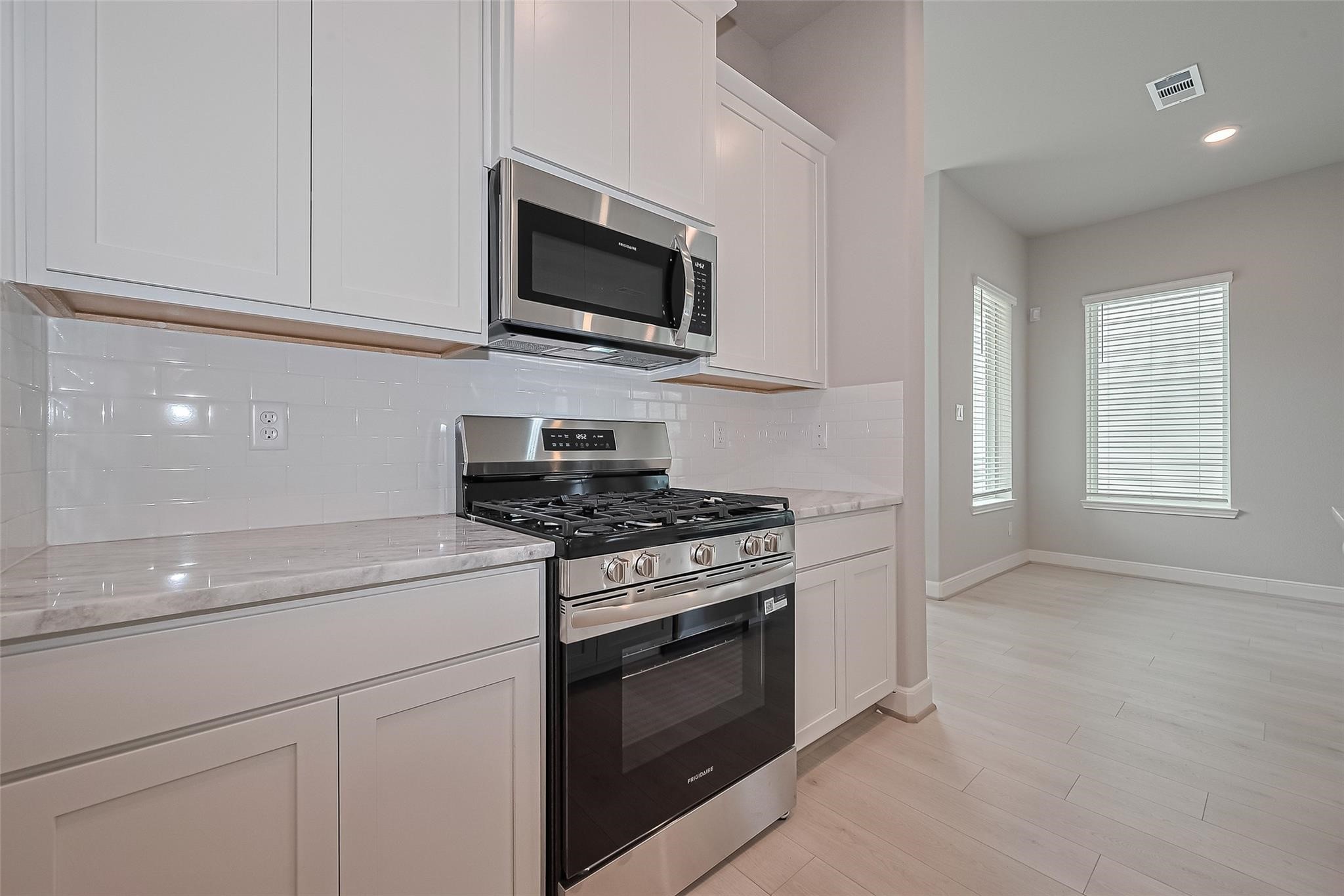 8933 Grovner Place Houston, TX 77080 - Photo 12 of 48 a kitchen with stainless steel appliances a sink dishwasher stove and microwave