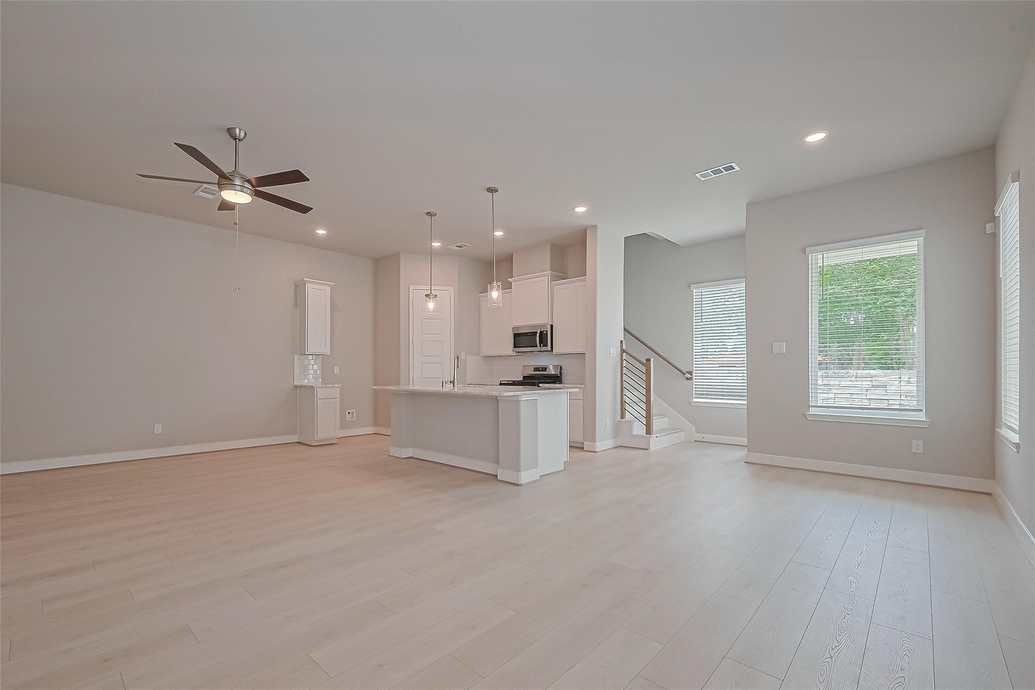 8933 Grovner Place Houston, TX 77080 - Photo 7 of 48 a view of an empty room with a kitchen