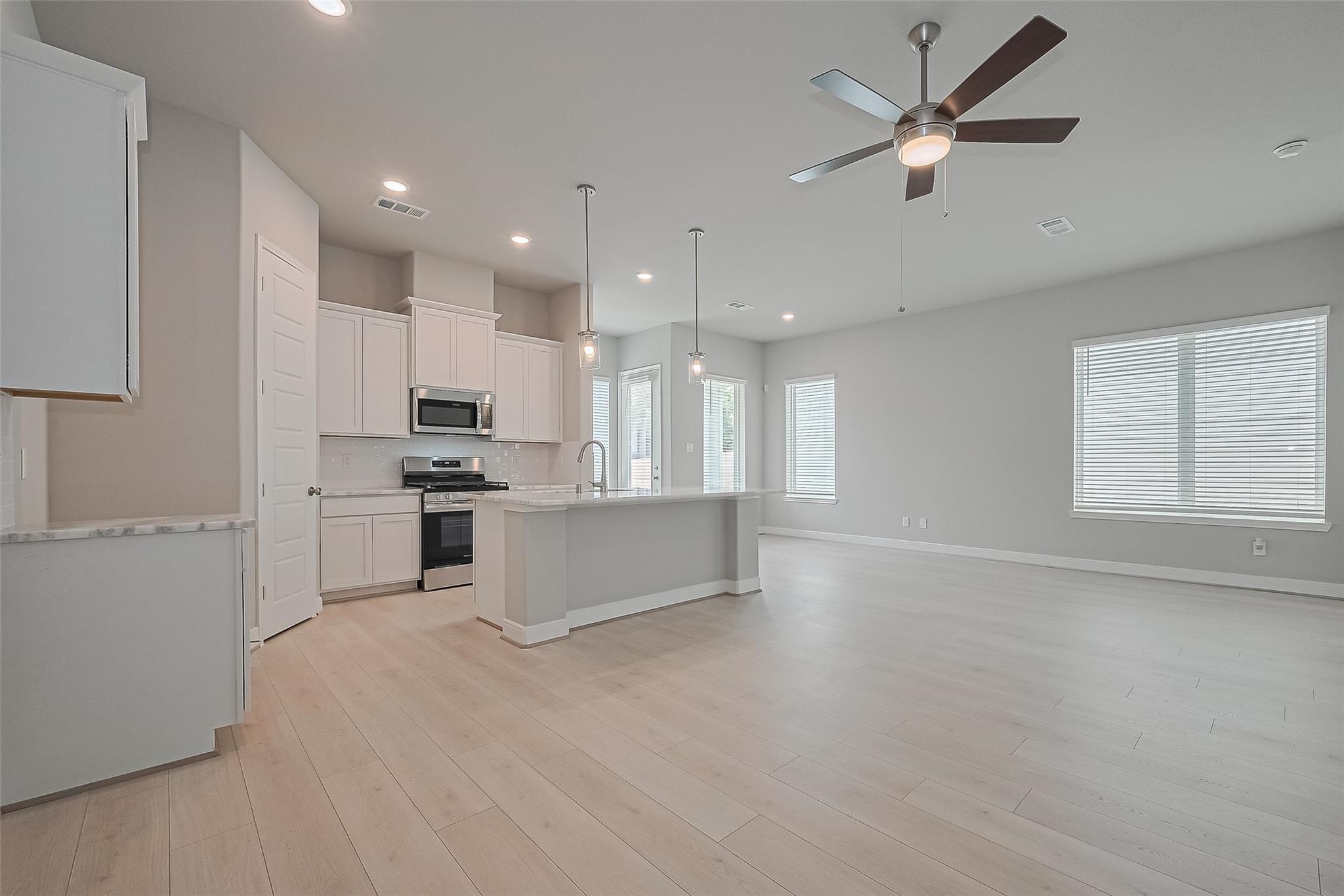 8933 Grovner Place Houston, TX 77080 - Photo 8 of 48 a large kitchen with cabinets