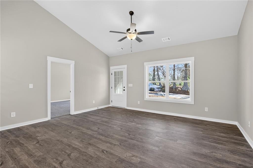 1549 Winn Road Douglasville, GA 30134 - Photo 11 of 36 a view of an empty room with wooden floor and a window