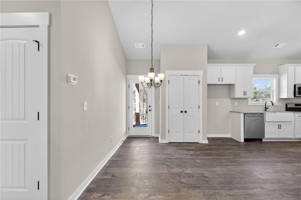 1549 Winn Road Douglasville, GA 30134 - Photo 13 of 36 a view of a kitchen with refrigerator and white cabinets