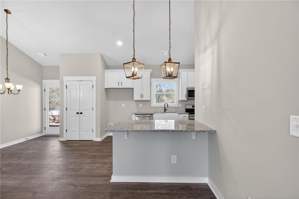 1549 Winn Road Douglasville, GA 30134 - Photo 14 of 36 a view of kitchen with stainless steel appliances granite countertop cabinets and wooden floor