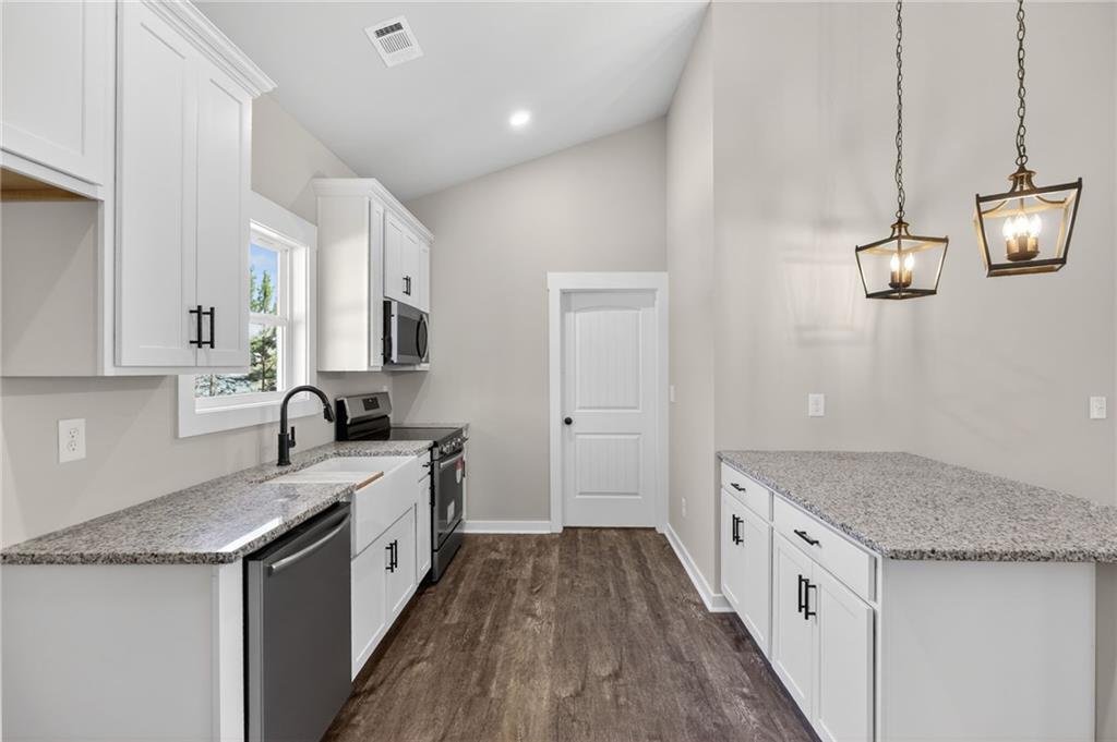 1549 Winn Road Douglasville, GA 30134 - Photo 15 of 36 a kitchen with a sink stove and cabinets