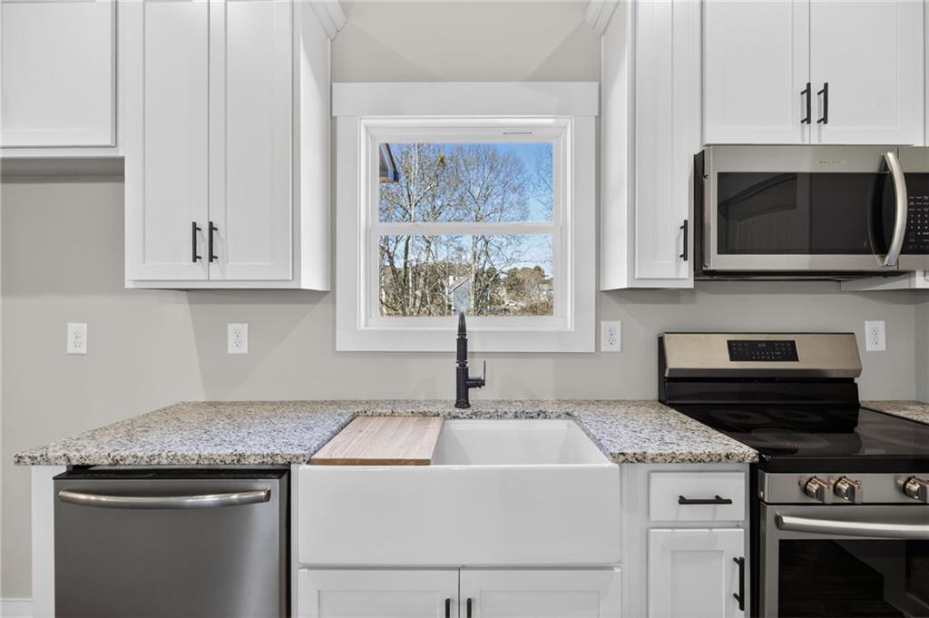 1549 Winn Road Douglasville, GA 30134 - Photo 16 of 36 a kitchen with a stove and a microwave