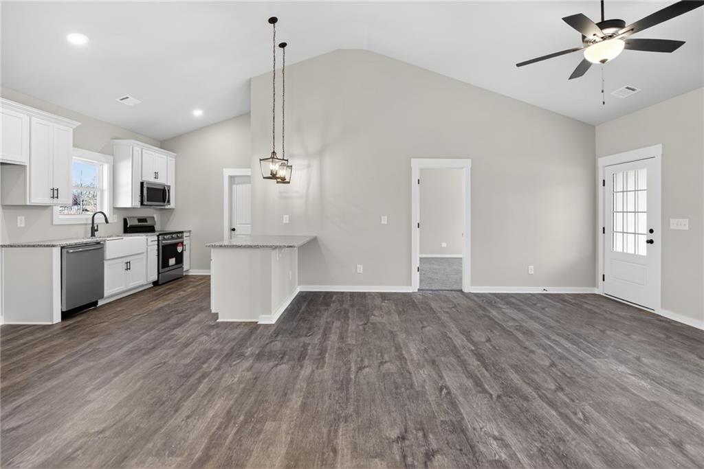 1549 Winn Road Douglasville, GA 30134 - Photo 19 of 36 a view of a kitchen with a sink dishwasher a kitchen island with wooden floor and cabinets