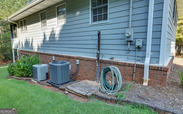 a view of a swimming pool with a patio and a yard