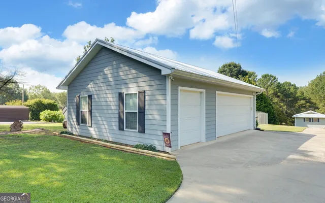 an aerial view of a houses with a yard