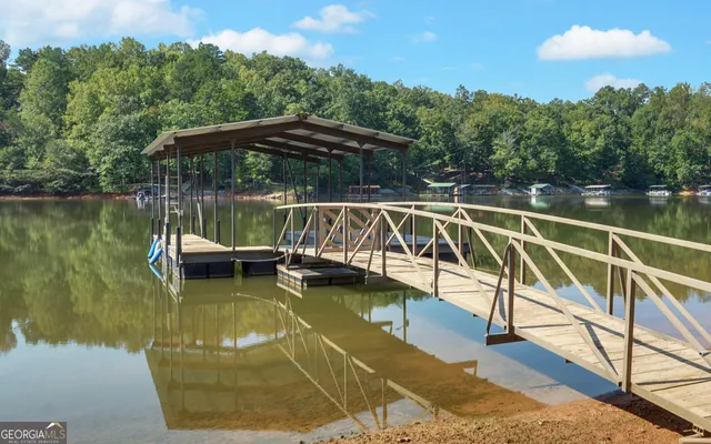 an aerial view of a house with a yard and lake view