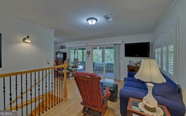 a dining room with furniture and wooden floor