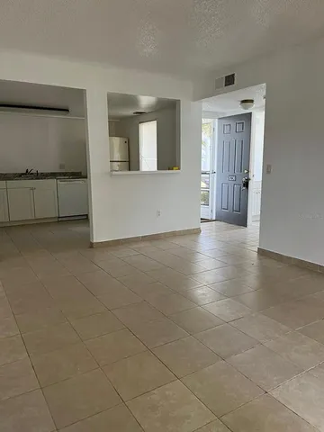 a view of a livingroom with an empty space and a window