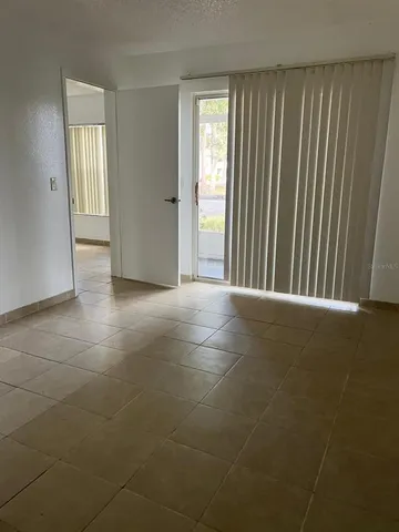 a view of a livingroom with an empty space and a window