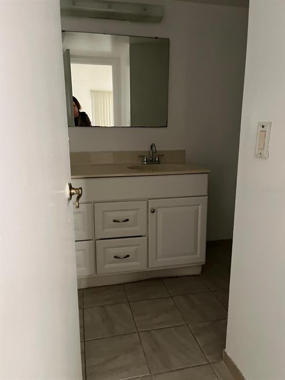 8236 Fairways Circle, Unit D102 Ocala, FL 34472 - Photo 10 of 12 a bathroom with a granite countertop sink and mirror