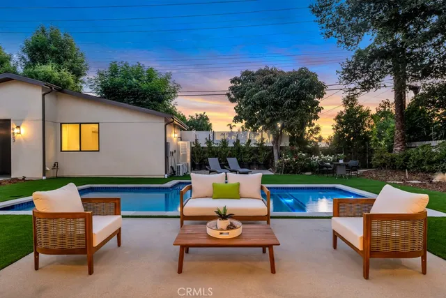 a backyard of a house with outdoor seating