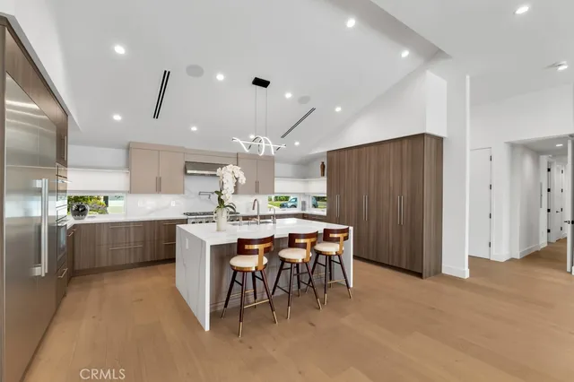 a large kitchen with a table and chairs in it