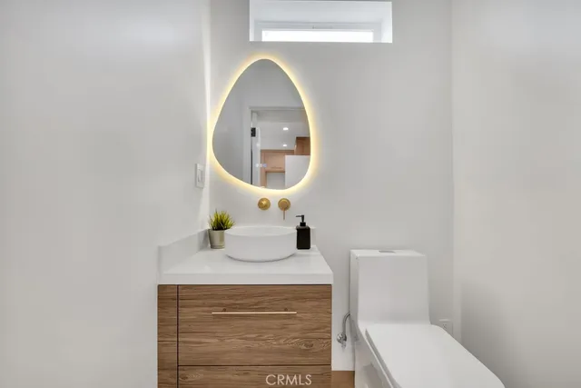 a living room with furniture kitchen and a table