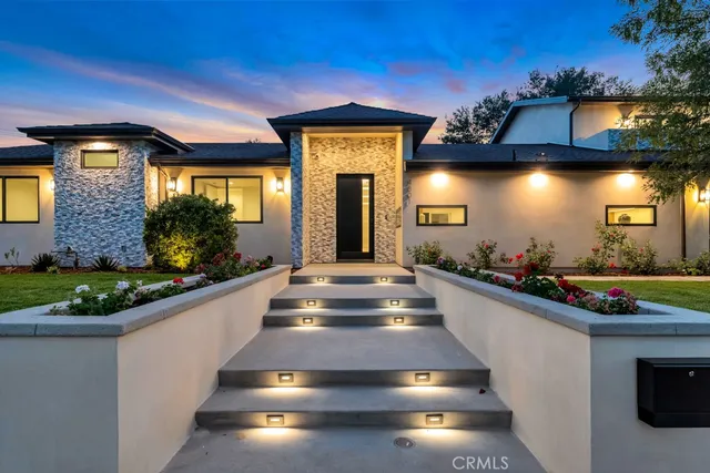a view of a house with pool and a yard
