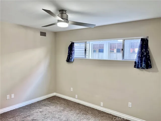 a view of room with window and ceiling fan