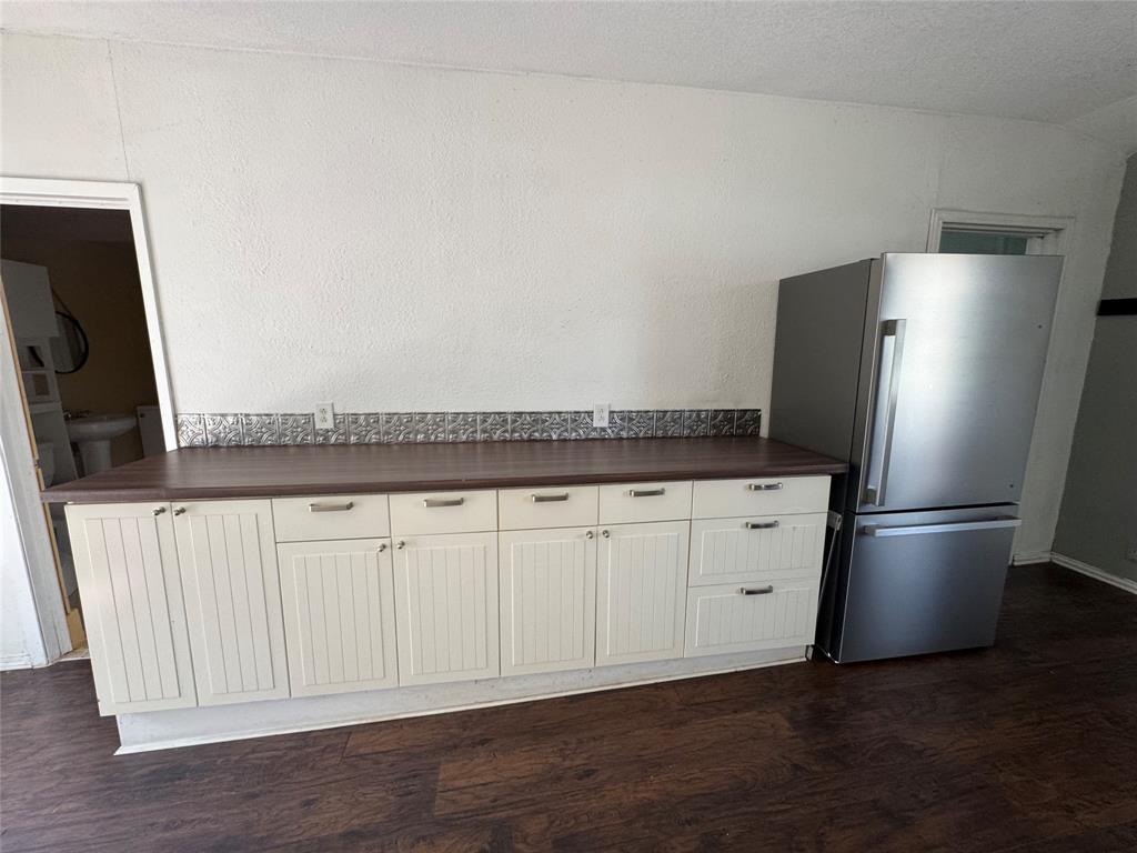 629 Harrison Lane Hurst, TX 76053 - Photo 12 of 20 a kitchen with stainless steel appliances white cabinets and a refrigerator