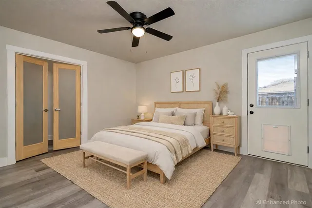 a bedroom with a large bed and a chandelier